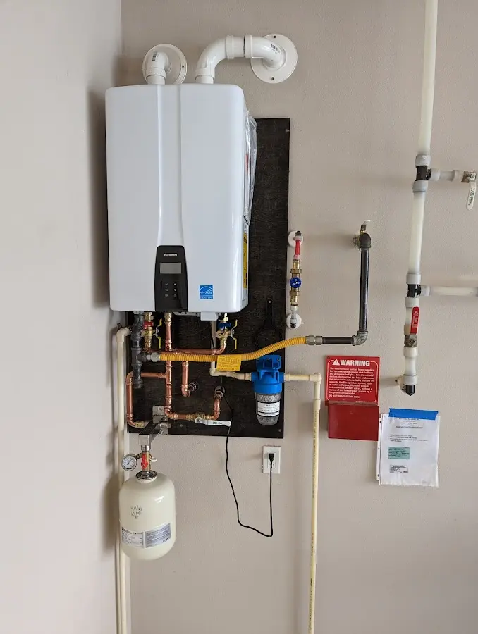 Professional plumber installing copper piping in a Lansing home